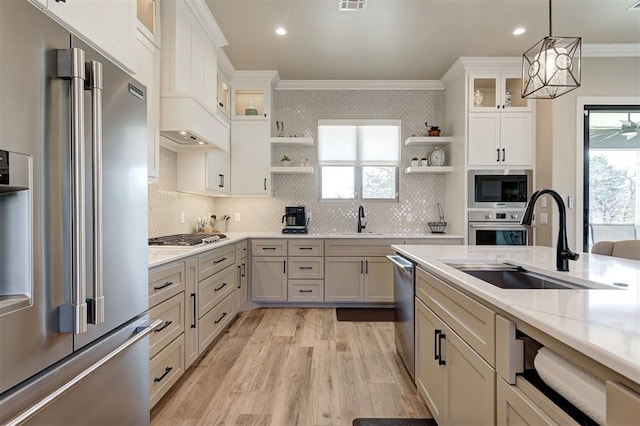 kitchen with ornamental molding, a sink, open shelves, and stainless steel appliances