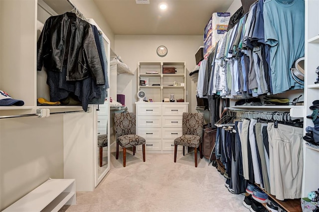 walk in closet with visible vents and light colored carpet