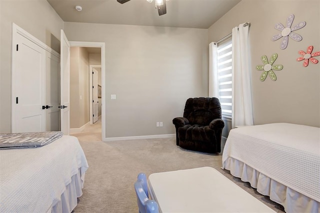 bedroom with baseboards, ceiling fan, and light carpet