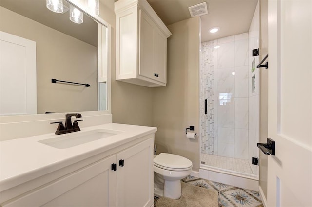 bathroom with a shower stall, vanity, visible vents, recessed lighting, and toilet