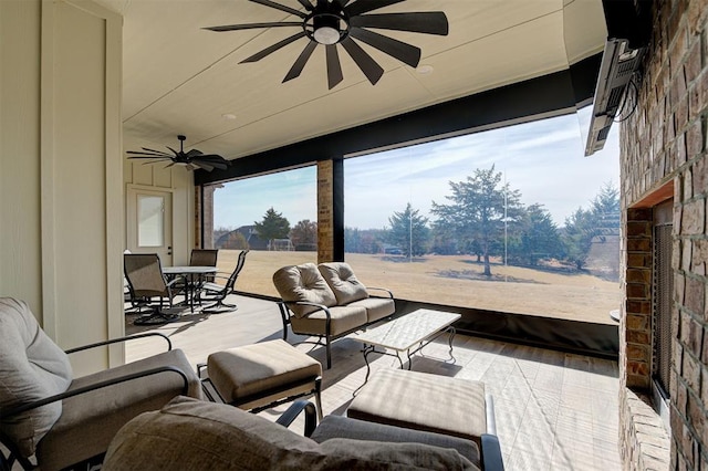 view of patio / terrace featuring an outdoor living space, outdoor dining area, and a ceiling fan