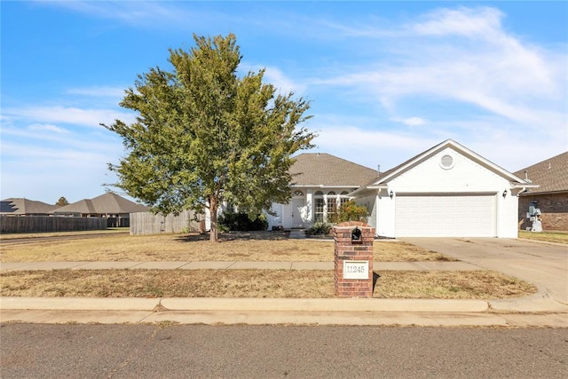 11245 NW 101st St, Yukon, OK 73099 - view of front of house featuring a garage and concrete driveway