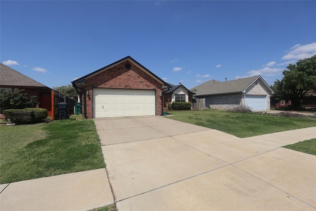 single story home featuring an attached garage, concrete driveway, a front yard, and brick siding