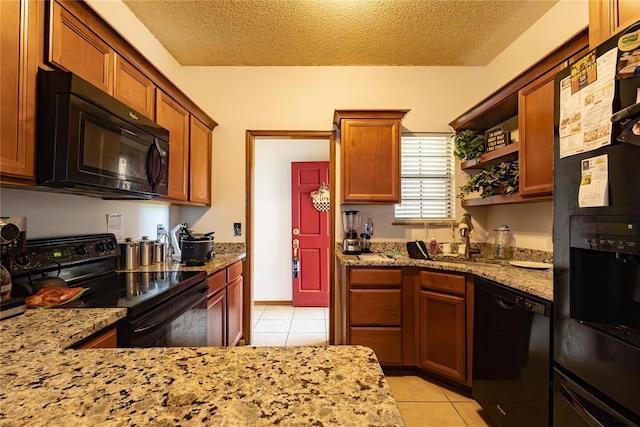 kitchen with light tile patterned floors, open shelves, a sink, black appliances, and light stone countertops