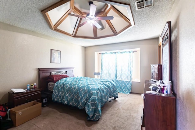 carpeted bedroom with a textured ceiling, visible vents, ceiling fan, and a textured wall