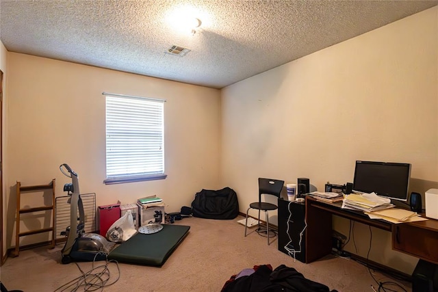 carpeted home office with visible vents and a textured ceiling