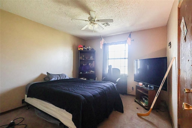 bedroom with visible vents, ceiling fan, a textured ceiling, and carpet