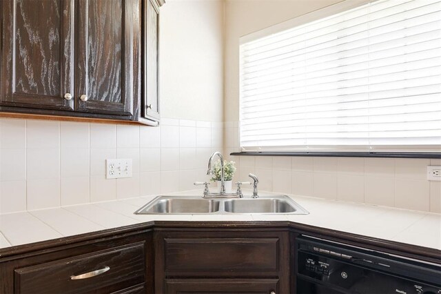 5309 SE 78th St, Oklahoma City, OK 73135 - kitchen with black dishwasher, a sink, dark brown cabinetry, light countertops, and tasteful backsplash