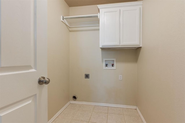 5309 SE 78th St, Oklahoma City, OK 73135 - clothes washing area with electric dryer hookup, washer hookup, light tile patterned flooring, baseboards, and cabinet space