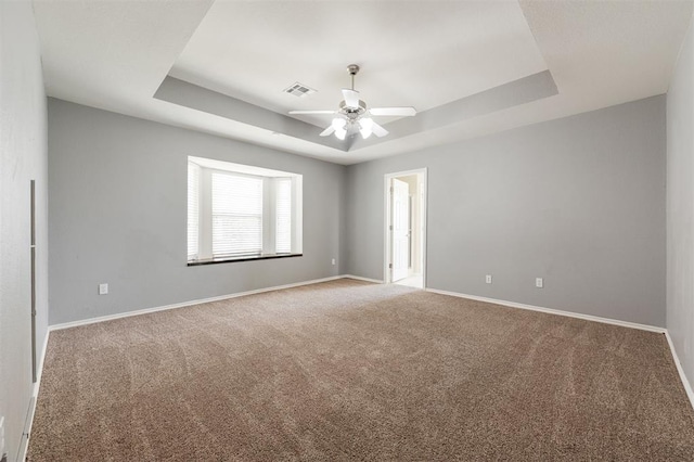 5309 SE 78th St, Oklahoma City, OK 73135 - unfurnished room with a raised ceiling, carpet flooring, baseboards, and a ceiling fan