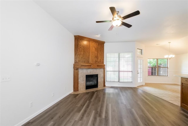 1417 Mayer Dr, Yukon, OK 73099 - unfurnished living room featuring a fireplace, a chandelier, ceiling fan, vaulted ceiling, and wood finished floors