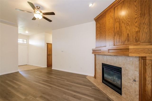 1417 Mayer Dr, Yukon, OK 73099 - unfurnished living room featuring a fireplace, ceiling fan, and wood finished floors