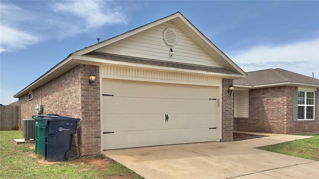 view of front of home featuring brick siding, a garage, roof with shingles, cooling unit, and concrete driveway