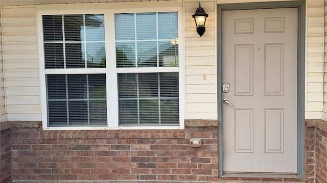 entrance to property with brick siding