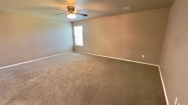 empty room with baseboards, visible vents, ceiling fan, and carpet flooring