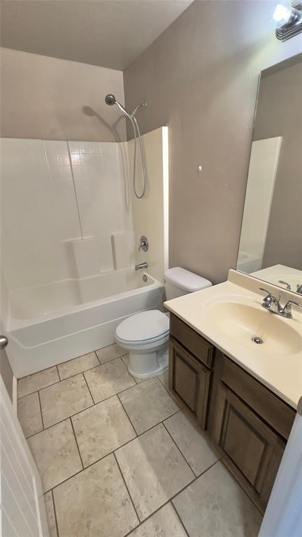 bathroom featuring shower / washtub combination, toilet, and vanity