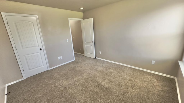 unfurnished bedroom with carpet and baseboards