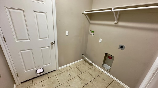 washroom featuring light tile patterned floors, laundry area, electric dryer hookup, hookup for a washing machine, and baseboards