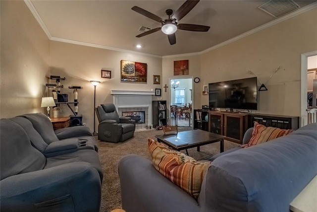 carpeted living area featuring ornamental molding, a ceiling fan, and visible vents
