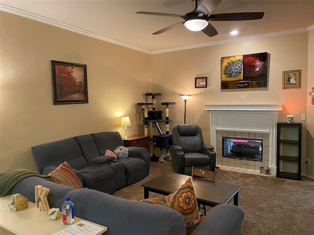 carpeted living room with a tile fireplace, ceiling fan, crown molding, and baseboards