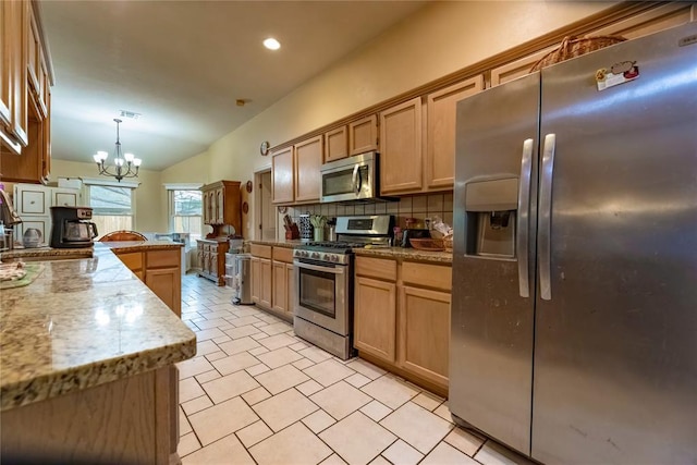 kitchen with a sink, stainless steel appliances, decorative backsplash, a peninsula, and lofted ceiling