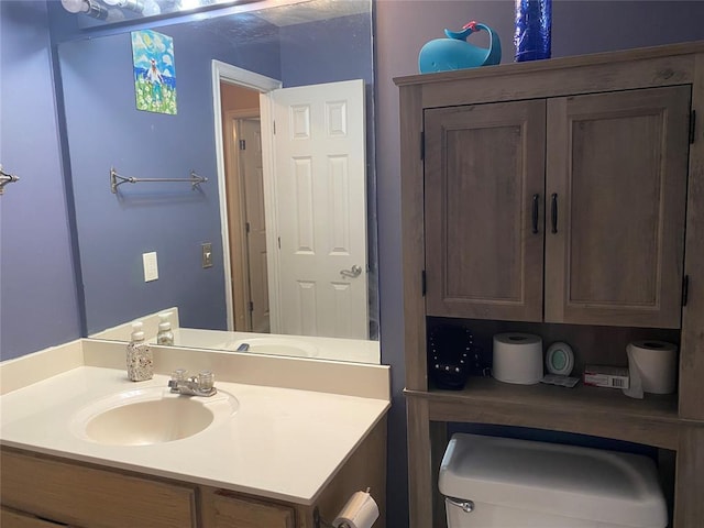 bathroom with toilet and vanity