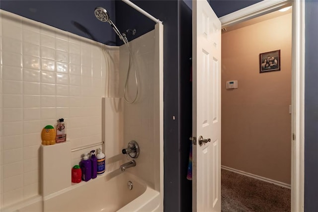bathroom featuring baseboards and shower / bath combination