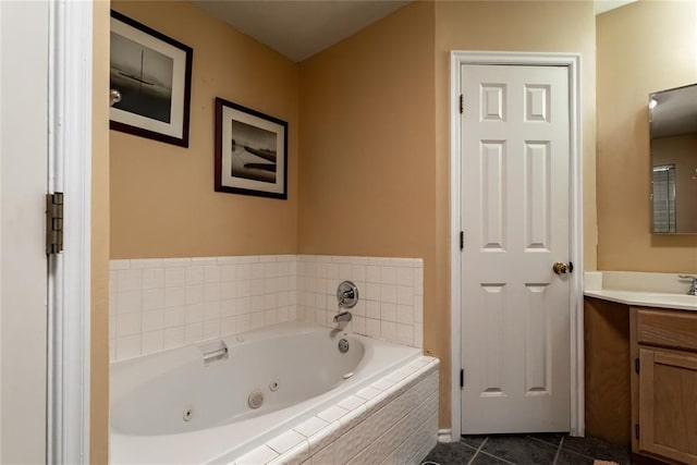 full bath with a tub with jets, tile patterned floors, and vanity