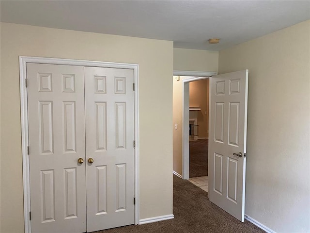 17413 Platinum Ln, Edmond, OK 73012 - unfurnished bedroom featuring dark carpet, a closet, and baseboards