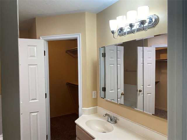 17413 Platinum Ln, Edmond, OK 73012 - bathroom featuring vanity and a spacious closet