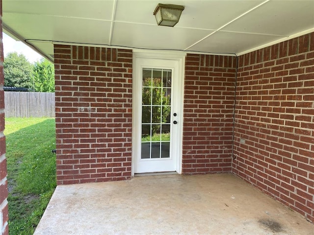 17413 Platinum Ln, Edmond, OK 73012 - view of exterior entry featuring a patio area and brick siding