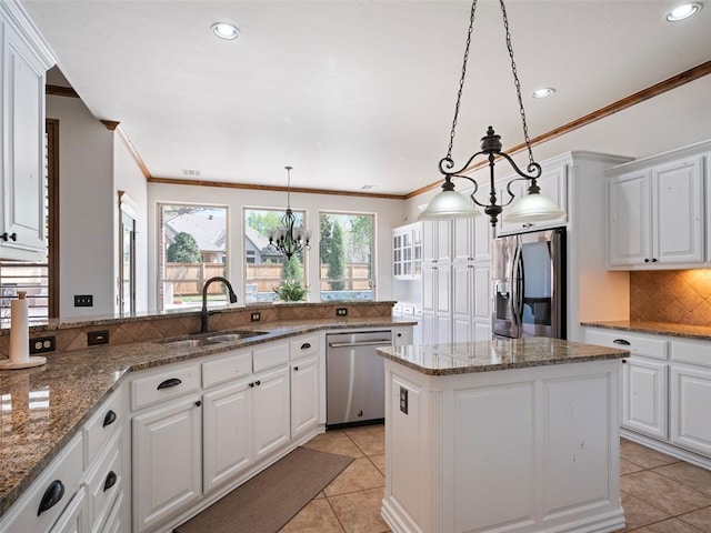 kitchen with light tile patterned floors, ornamental molding, appliances with stainless steel finishes, a sink, and backsplash