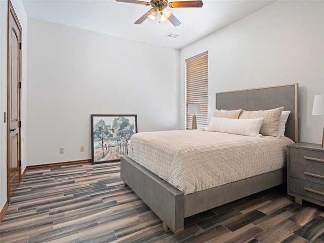 bedroom featuring dark wood-type flooring, visible vents, baseboards, and ceiling fan