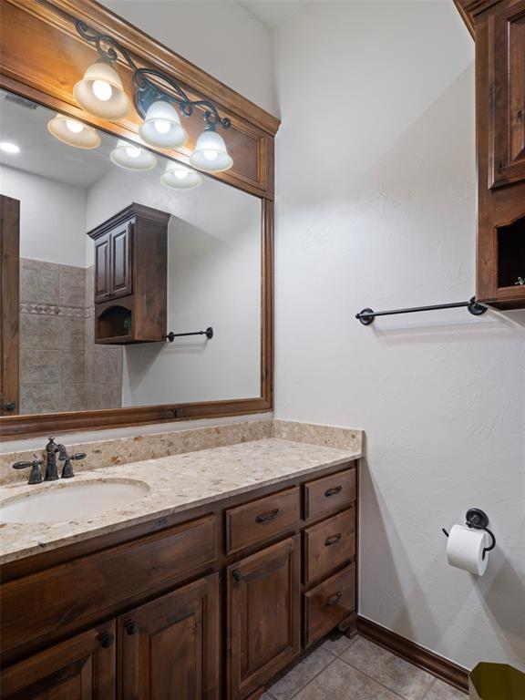 bathroom with tile patterned floors and vanity