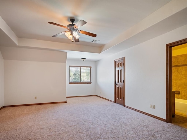 unfurnished room with light carpet, baseboards, a ceiling fan, and visible vents