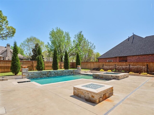 view of pool featuring a fenced in pool, a patio, an in ground hot tub, and a fenced backyard