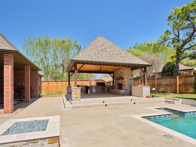view of pool with a fenced in pool, a patio area, a fenced backyard, a gazebo, and an outdoor fireplace
