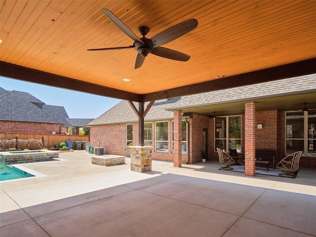 view of patio featuring fence, ceiling fan, a fenced in pool, and an in ground hot tub