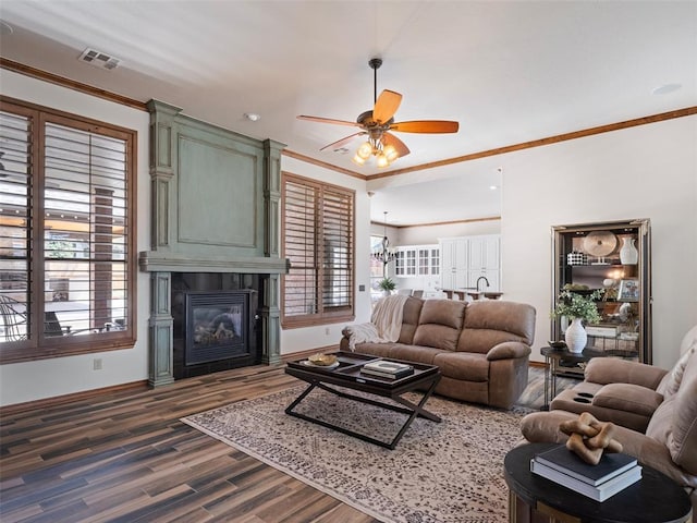 4200 Slate Bridge Rd, Edmond, OK 73034 - living area with crown molding, ceiling fan, plenty of natural light, dark wood-type flooring, and a fireplace