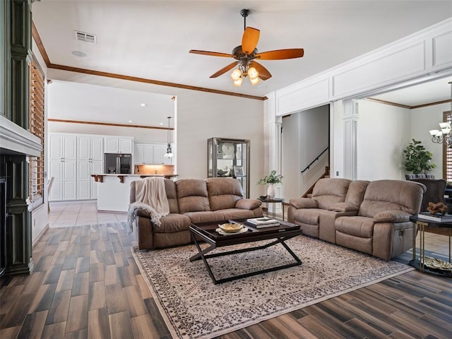 4200 Slate Bridge Rd, Edmond, OK 73034 - living room with wood finished floors, ceiling fan, crown molding, decorative columns, and stairs