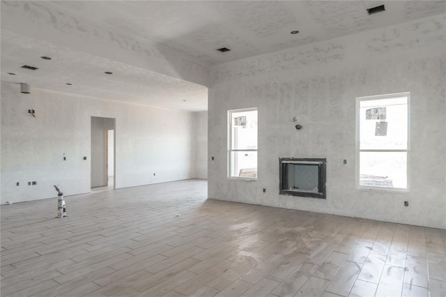 9204 SW 35th St, Oklahoma City, OK 73179 - unfurnished living room featuring wood finished floors and a fireplace