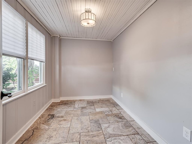 1016 E Edwards St, Edmond, OK 73034 - empty room featuring baseboards, wood ceiling, and stone tile floors