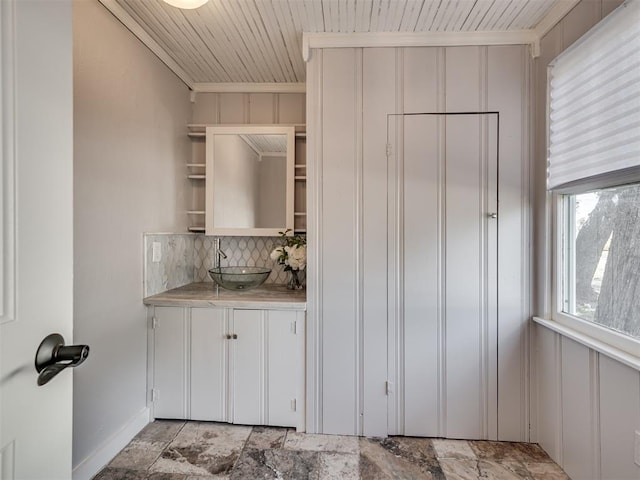 1016 E Edwards St, Edmond, OK 73034 - kitchen with light countertops, wooden ceiling, a sink, open shelves, and decorative backsplash