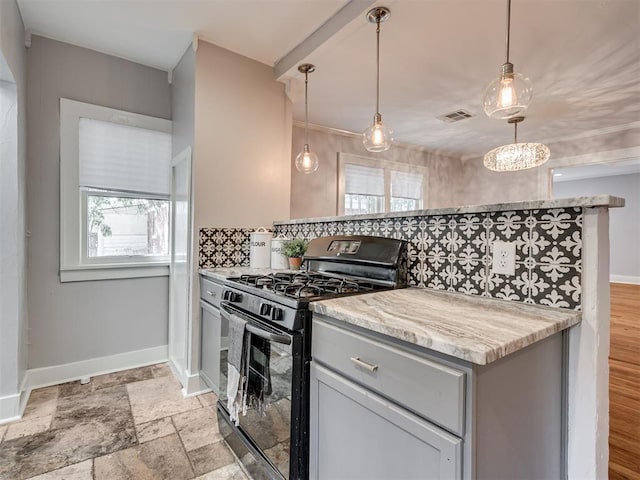 1016 E Edwards St, Edmond, OK 73034 - kitchen with gray cabinetry, baseboards, black gas range, and plenty of natural light