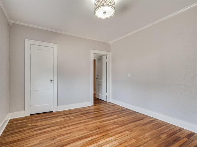 1016 E Edwards St, Edmond, OK 73034 - empty room featuring ornamental molding, baseboards, and light wood-type flooring