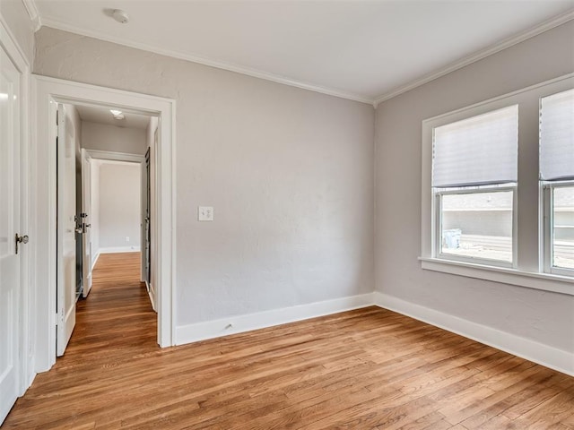 1016 E Edwards St, Edmond, OK 73034 - spare room with crown molding, baseboards, and light wood-type flooring