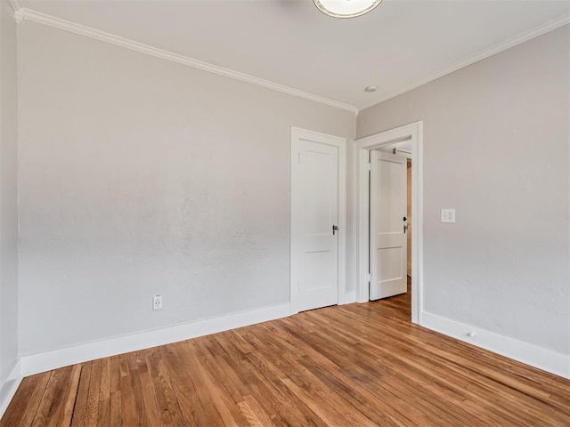 1016 E Edwards St, Edmond, OK 73034 - empty room with baseboards, ornamental molding, and wood finished floors