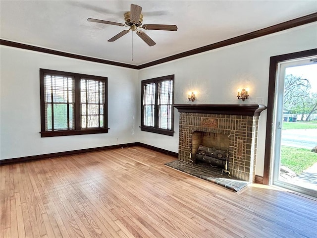 1909 N Gatewood Ave, Oklahoma City, OK 73106 - unfurnished living room with crown molding, a ceiling fan, a tile fireplace, wood-type flooring, and baseboards