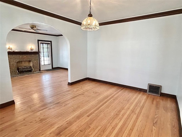 1909 N Gatewood Ave, Oklahoma City, OK 73106 - interior space featuring arched walkways, visible vents, light wood-type flooring, and baseboards
