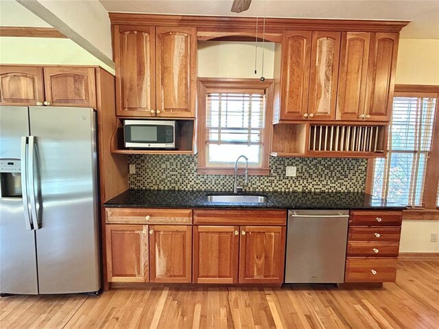1909 N Gatewood Ave, Oklahoma City, OK 73106 - kitchen with stainless steel appliances, light wood finished floors, brown cabinets, and a sink